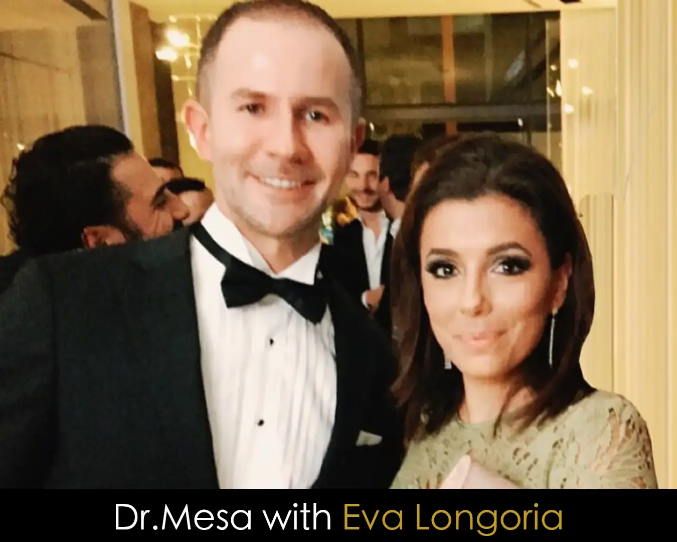 Dr. John Mesa with Eva Longoria at a formal event.